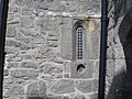 Castle window with gun hole