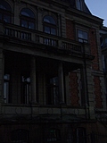 Creepy old building with stone balcony 2
