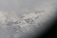 Snow-covered fields seen through clouds 1