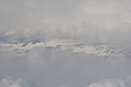 Snow-covered fields seen through clouds 2