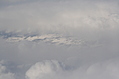 Snow-covered fields seen through clouds 4