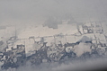 Snow-covered fields seen through clouds 5