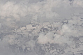 Snow-covered fields seen through clouds 6