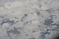 Snow-covered fields seen through clouds 7