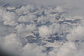 Snow-covered fields seen through clouds 10