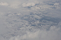 Snow-covered fields seen through clouds 12