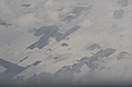 Snow-covered fields seen through clouds 15