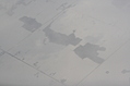 Snow-covered fields seen through clouds 16