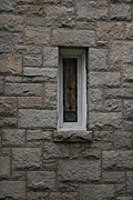 Stained-glass window in stone wall
