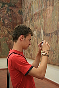 Boy photographing fresco