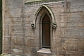 Arched stone window with carvings and inscription