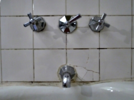 [picture: Faucets and cracked tiles]