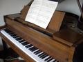[Picture: Baby grand piano]