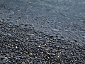 [Picture: Wet pebbles at the edge of the shore]