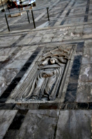 [picture: bas-relief gravestone in the floor]
