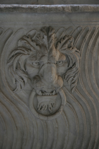 [Picture: Stone lion’s head with ring 1]