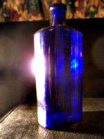 [picture: Old medicine bottle with lens flare]
