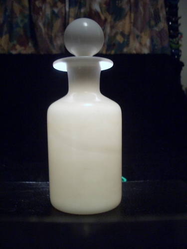 [Picture: Antique white glass bottle]