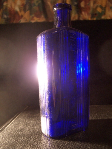 [Picture: Old medicine bottle with lens flare]