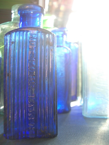 [Picture: Blue antique medicine bottle with strong light]