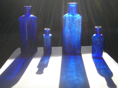 [Picture: Four medicine bottles with sunlight streaming past]