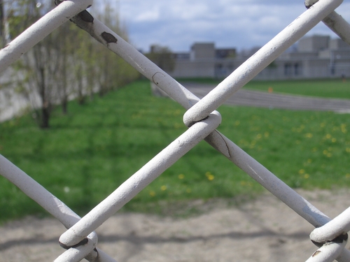 [Picture: chain-link fence outside school]