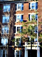 [picture: Brick building with bay windows and trees]