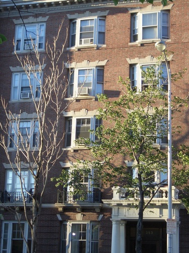 [Picture: Brick building with bay windows and trees]