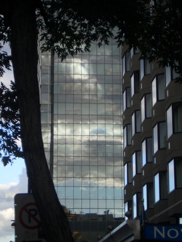 [Picture: Sunset reflected in glass skyscraper]