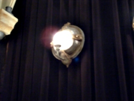 [picture: porthole mirror lamp with candle, lit up]