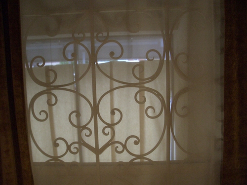 [Picture: Wrought iron through net curtains]