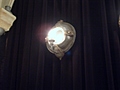 [Picture: porthole mirror lamp with candle, lit up]