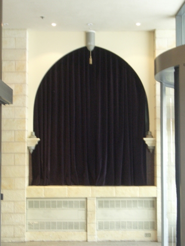 [Picture: Arch with velvet curtain]