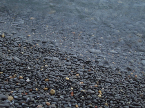 [Picture: Wet pebbles at the edge of the shore]