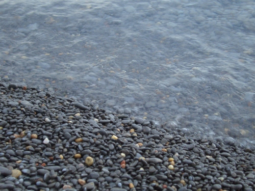 [Picture: Wet pebbles at the edge of the shore 2]