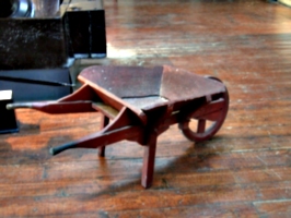 [picture: Wooden wheelbarrow]
