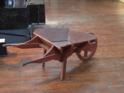 [Picture: Wooden wheelbarrow]