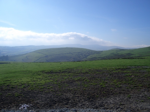 [Picture: Muddy field and green hill]