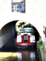 [picture: Canal boat under bridge]