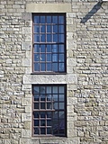 [Picture: Sash windows in stone wall]