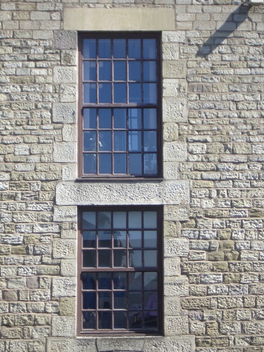 [Picture: Sash windows in stone wall]