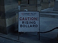 [Picture: Caution: Rising Bollard]
