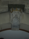 [Picture: Stone head with gold crown]