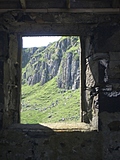 [Picture: Cliff seen though old window]