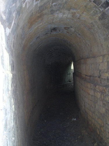 [Picture: A curved brick tunnel outside]