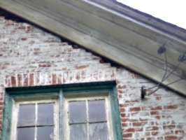 [picture: Brick damage at the eaves: another view]