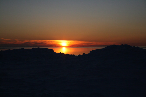 [Picture: Sunset on snow-covered beach]