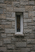 [Picture: Stained-glass window in stone wall]