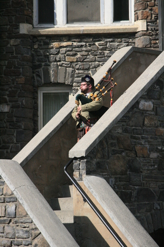 [Picture: Lone bagpiper on the castle walls.]