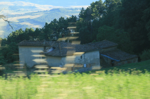 [Picture: Tuscany farm with distant landscape]